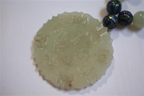 A celadon jade and two colour enamel bead necklace with carved jade pendant, 32in.